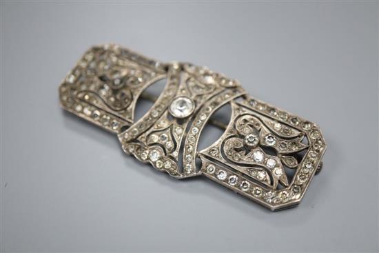 A 1920s style pierced white metal and paste set brooch, 64mm.